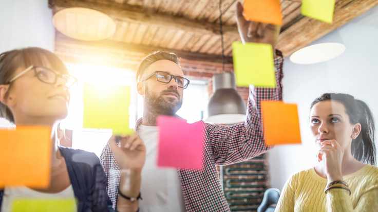 Jefe del área del marketing mostrando a su equipo de trabajo la estrategía de marketing digital para sus clientes.